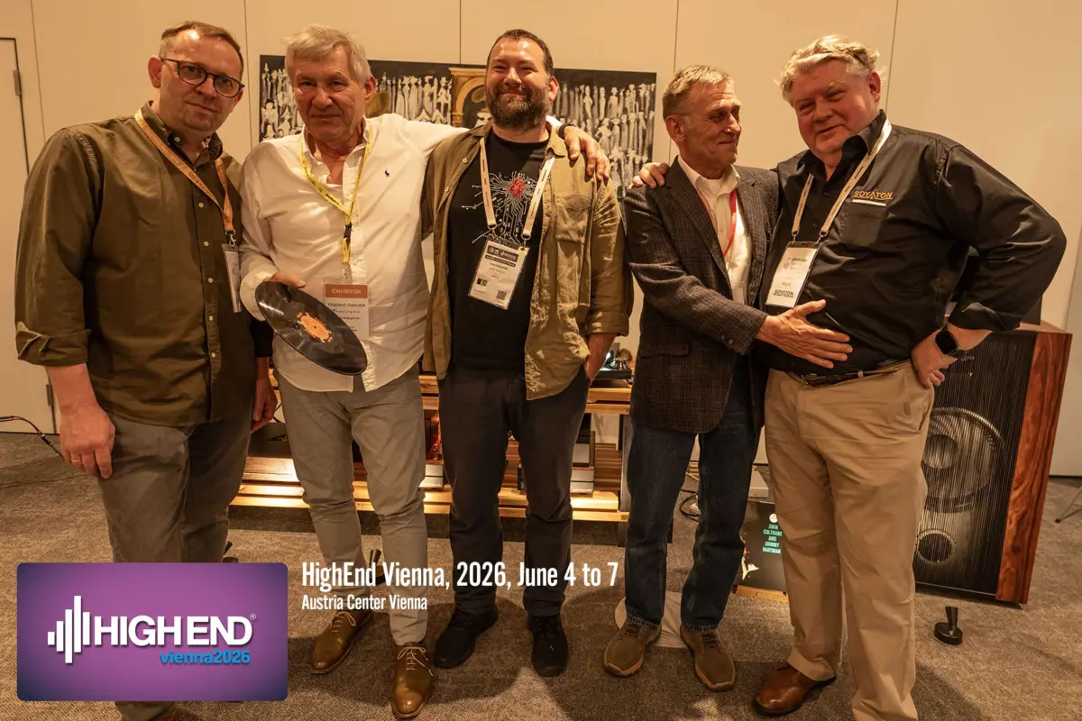 Five men at the Destination Audio room at High End Vienna 2026, one holding a vinyl record, with a horn speaker behind them