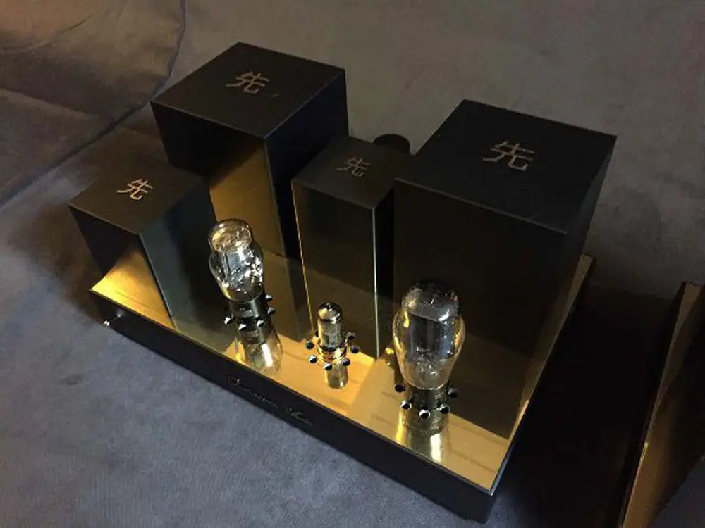 A Destination Audio 45 tube mono amplifier with three black transformer housings and two tubes