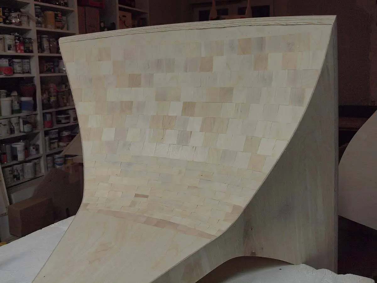 A horn flare built from end-grain wood blocks standing in the workshop
